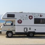 Recreational vehicle with tenant inside parked near Bend business